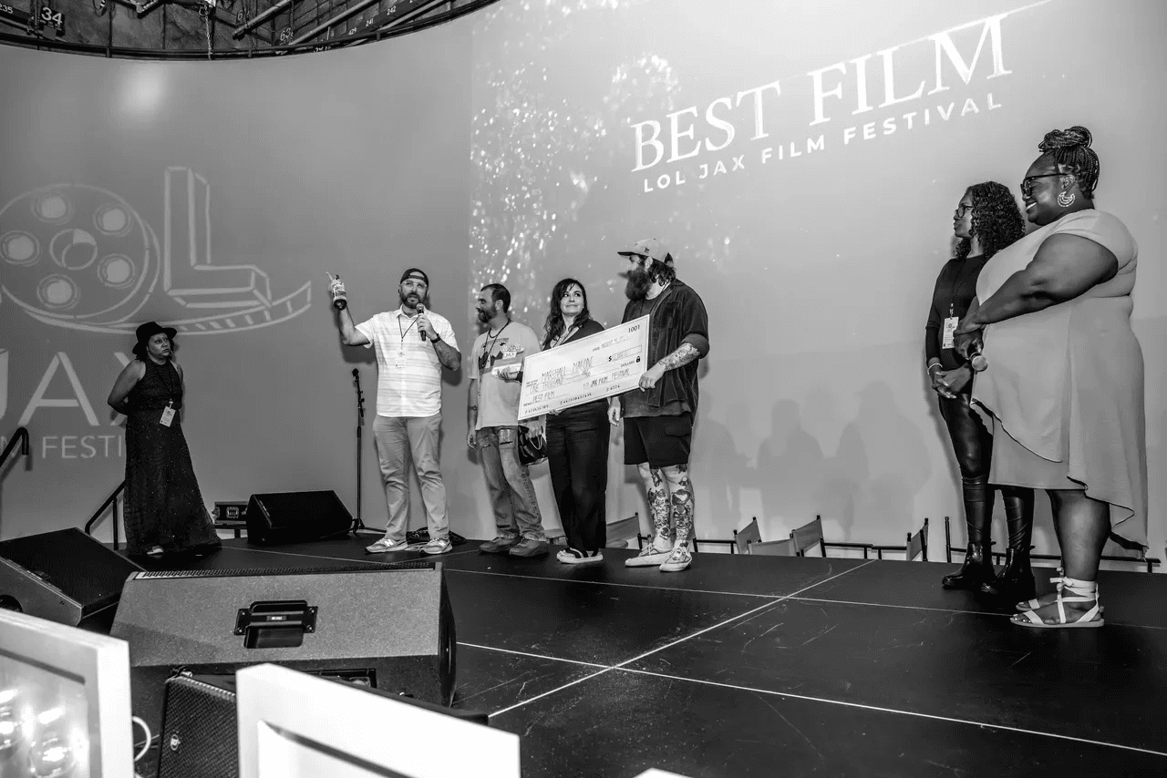 Marshall Malone and The Weight team on stage with the Best Film award
